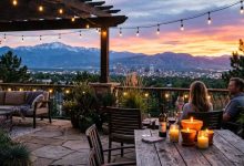 Outdoor patio in Denver with citronella candles during sunset and mountain backdrop