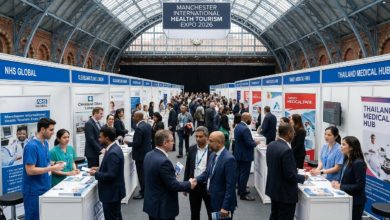 Visitors speaking with hospital and clinic representatives at exhibitor stands during the Manchester International Health Tourism Expo 2026 inside the historic Manchester Central Convention Complex