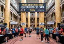 Runners collecting race packets at the Marine Corps Marathon Health and Fitness Expo 2026 inside the National Building Museum, Washington DC