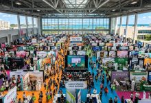 Aerial view of a busy health and wellness expo floor with exhibitor booths and visitors at Miami Beach Convention Center in November 2026